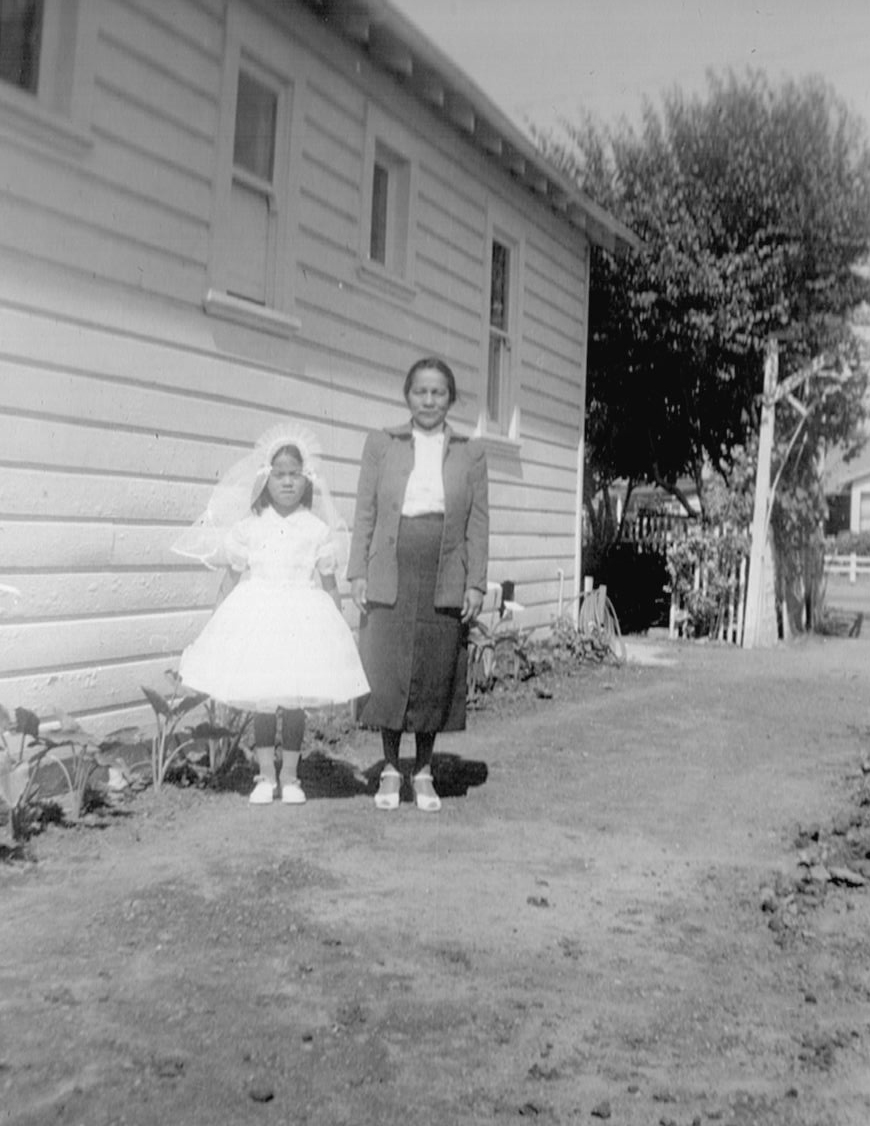 Stepha all dressed up on the day of her first communion ceremony. 